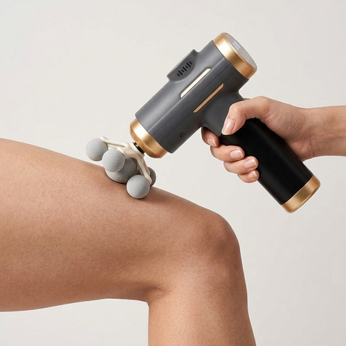 Percussion massage gun being used on knee